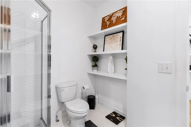 a bathroom with a toilet a sink and mirror
