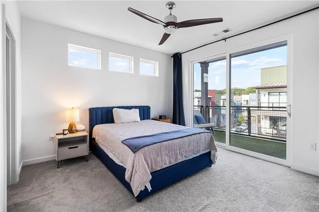 a spacious bedroom with a bed and a large window