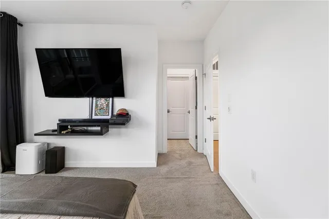 a living room with a flat screen tv and a lamp