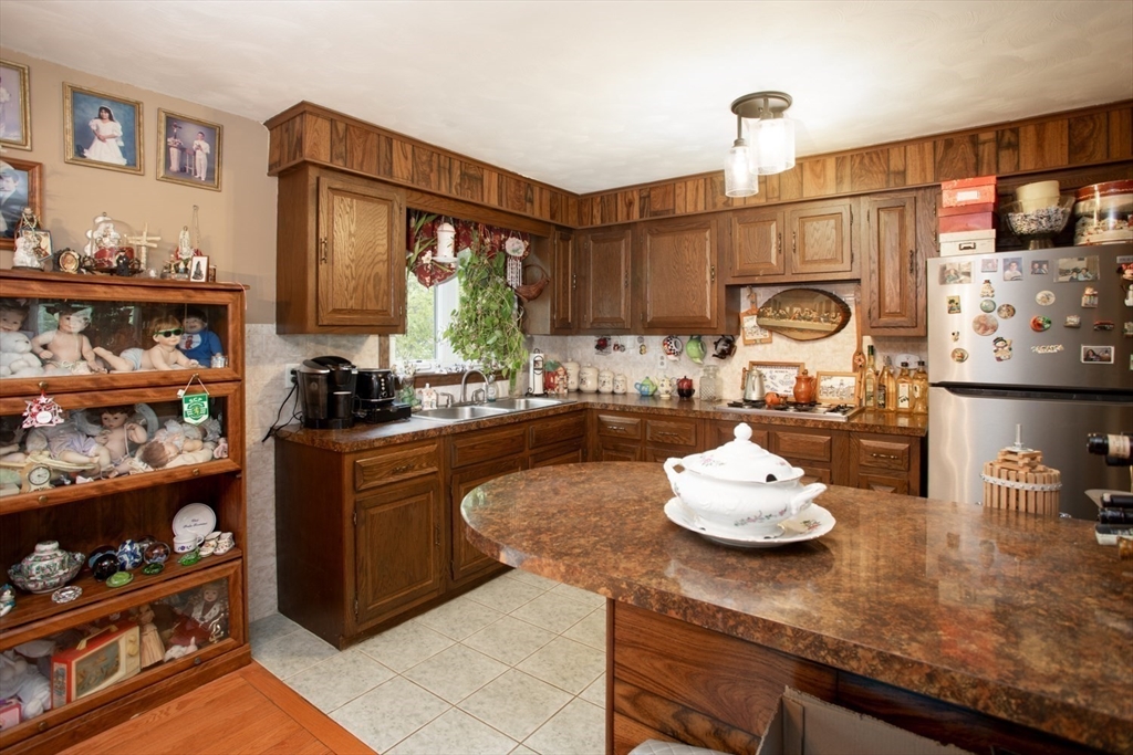 166 Stonehaven Road Fall River, MA 02723 - Photo 10 of 33 a kitchen with a refrigerator and a stove