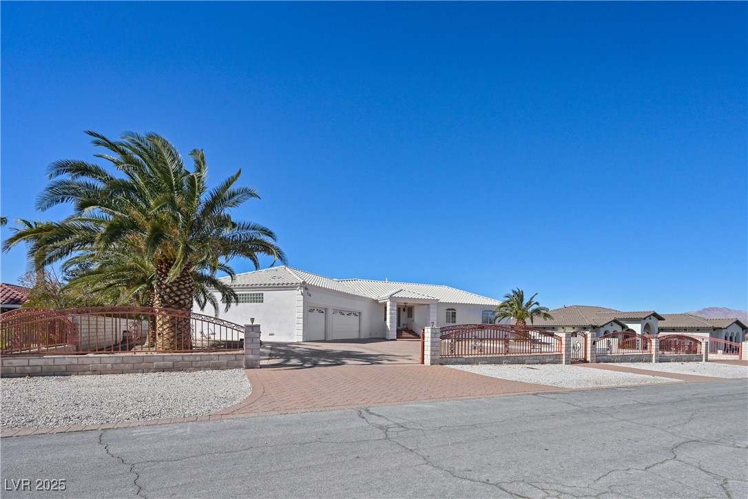 736 Kiel Street Henderson, NV 89015 - Photo 6 of 38 View of front of property with a fenced front yard, decorative driveway, an attached garage, and a gate