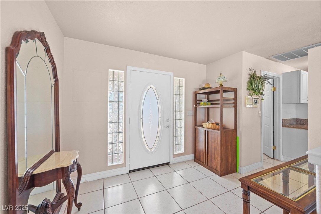736 Kiel Street Henderson, NV 89015 - Photo 8 of 38 Foyer entrance featuring light tile patterned floors, baseboards, and visible vents