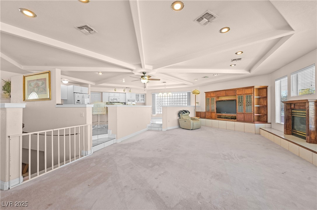 736 Kiel Street Henderson, NV 89015 - Photo 10 of 38 Unfurnished living room with visible vents, plenty of natural light, and a tiled fireplace