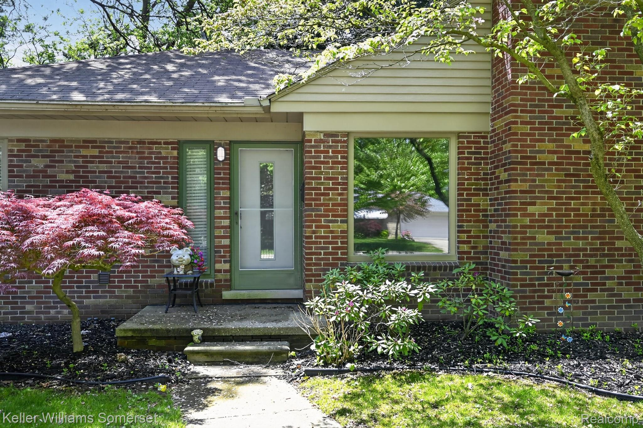 1681 Oxford Road Grosse Pointe, MI 48236 - Photo 3 of 25 Doorway to property featuring brick siding and a shingled roof