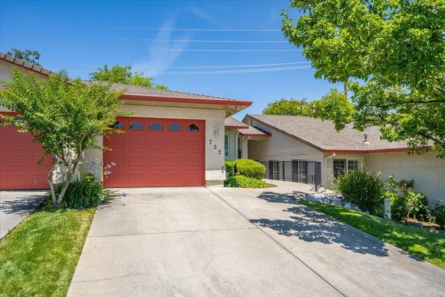 a front view of a house with a yard and a garage