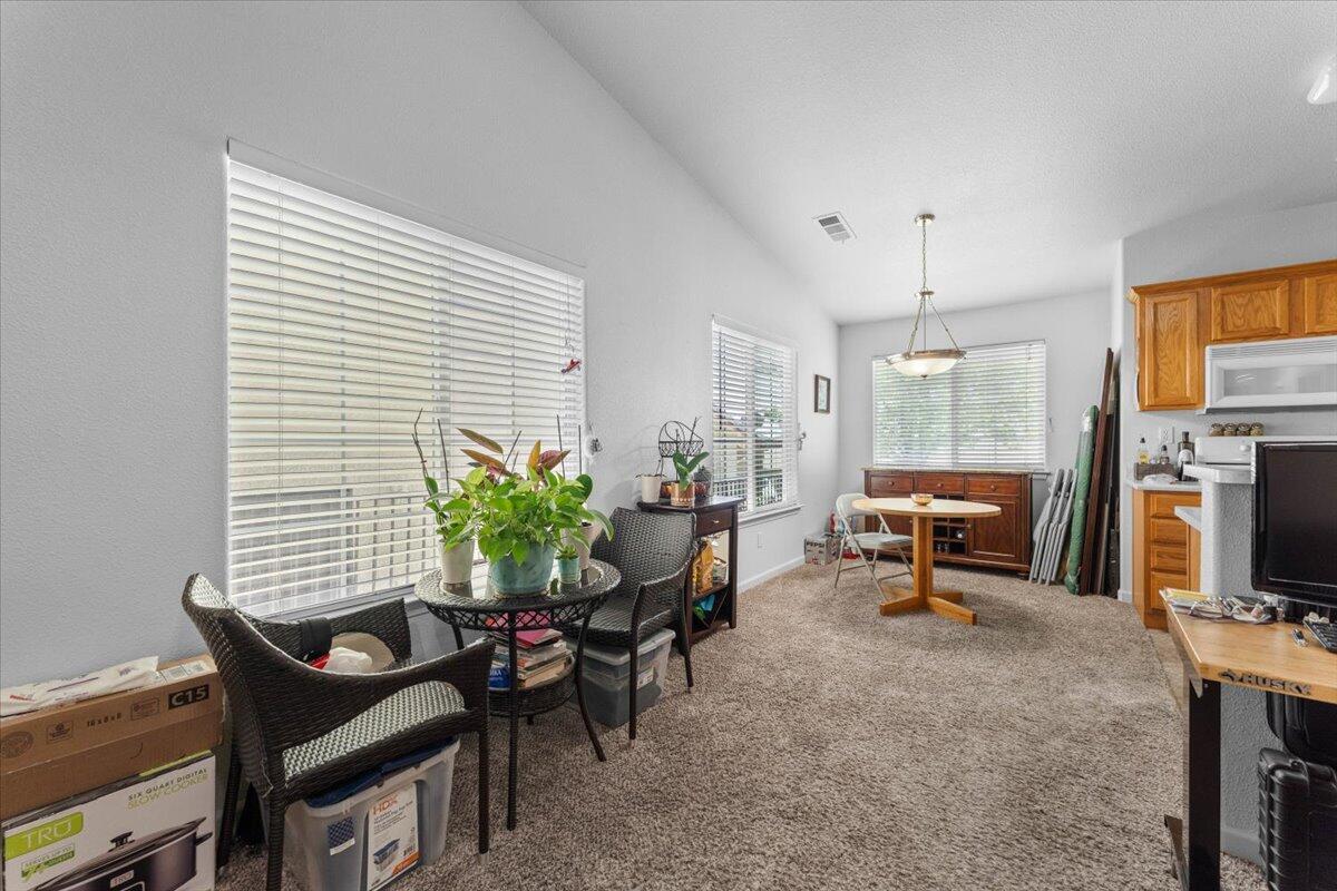 732 Stonebriar Trail Redding, CA 96003 - Photo 11 of 29 a living room with furniture a dining table and a potted plant
