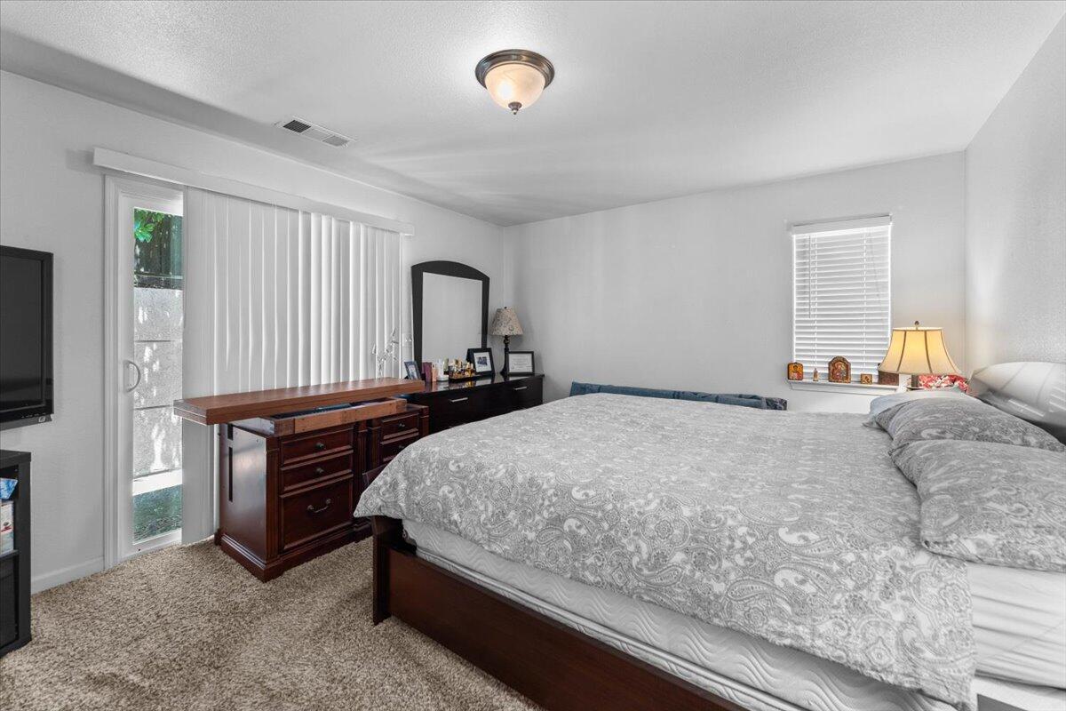 732 Stonebriar Trail Redding, CA 96003 - Photo 16 of 29 a bed room with a bed and a television