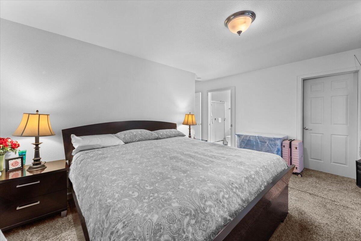 732 Stonebriar Trail Redding, CA 96003 - Photo 17 of 29 a bedroom with a bed and a lamp on dresser