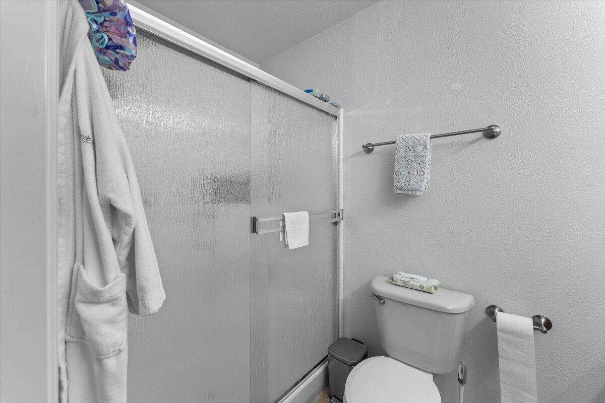 732 Stonebriar Trail Redding, CA 96003 - Photo 19 of 29 a white toilet sitting next to a shower