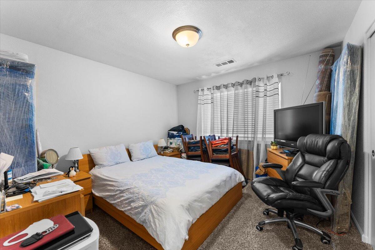 732 Stonebriar Trail Redding, CA 96003 - Photo 20 of 29 a bedroom with bed and a flat screen tv