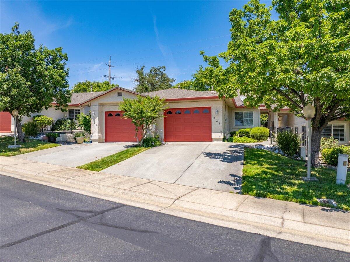 732 Stonebriar Trail Redding, CA 96003 - Photo 2 of 29 a front view of a house with a yard and a garage
