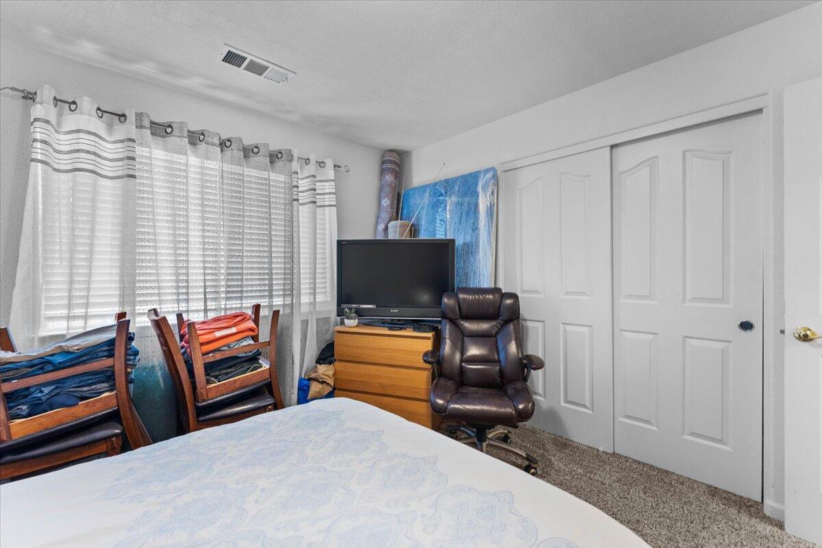 732 Stonebriar Trail Redding, CA 96003 - Photo 21 of 29 a bedroom with furniture and a flat screen tv