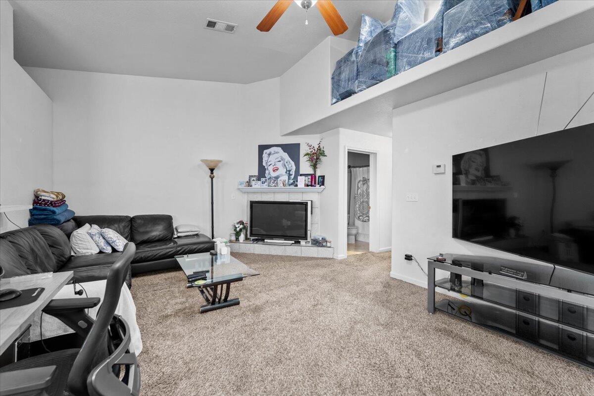 732 Stonebriar Trail Redding, CA 96003 - Photo 7 of 29 a living room with furniture and a flat screen tv