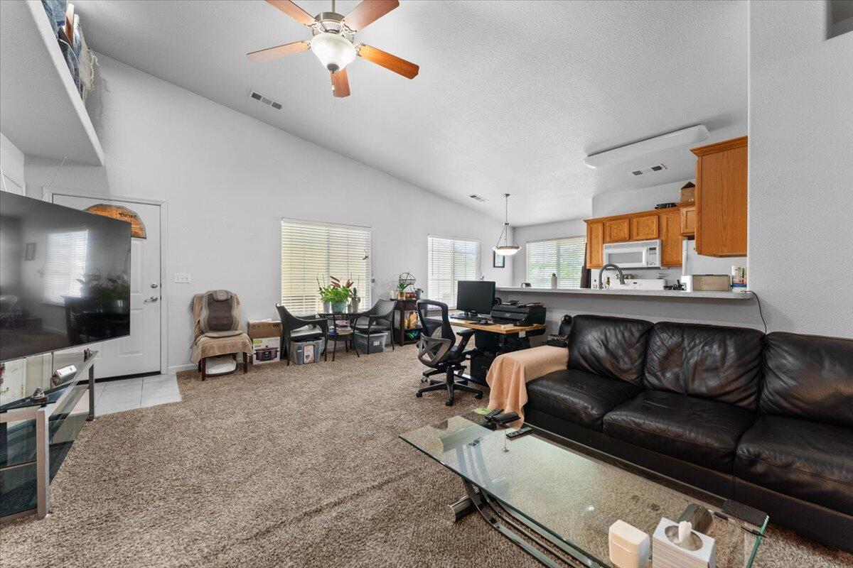 732 Stonebriar Trail Redding, CA 96003 - Photo 10 of 29 a living room with furniture and a flat screen tv