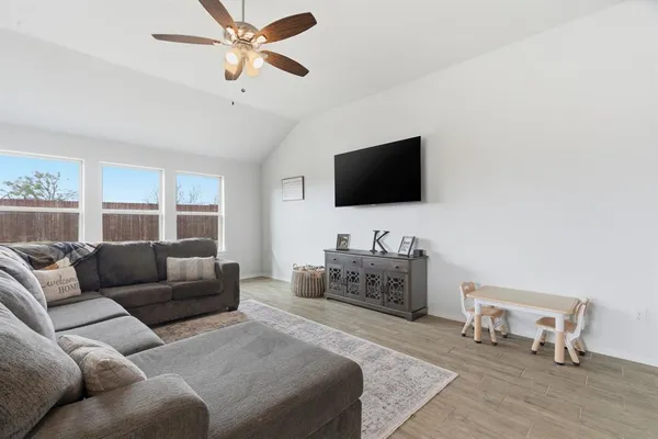 a living room with furniture and a flat screen tv