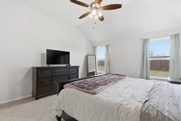 a bedroom with a bed and a ceiling fan