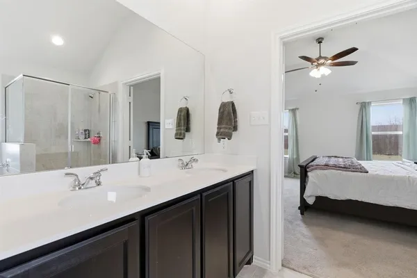 a bathroom with a sink a toilet and a shower