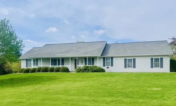 a front view of house with yard and green space