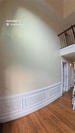 a view of a livingroom with wooden floor and stairs