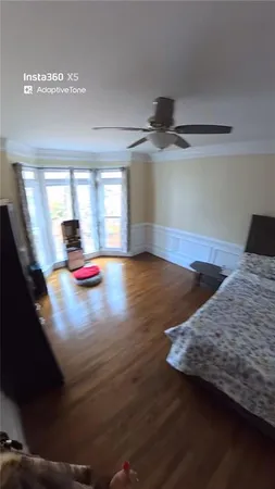 a view of a room with wooden floor and chair