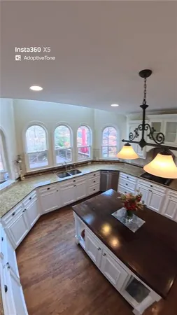 a kitchen with stainless steel appliances a stove a sink and a wooden cabinets