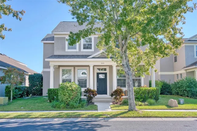 a front view of a house with garden and porch