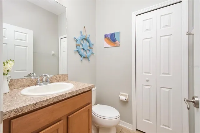 a bathroom with a granite countertop sink toilet and a mirror