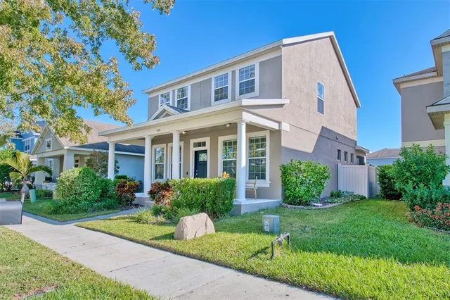 a front view of a house with garden and porch
