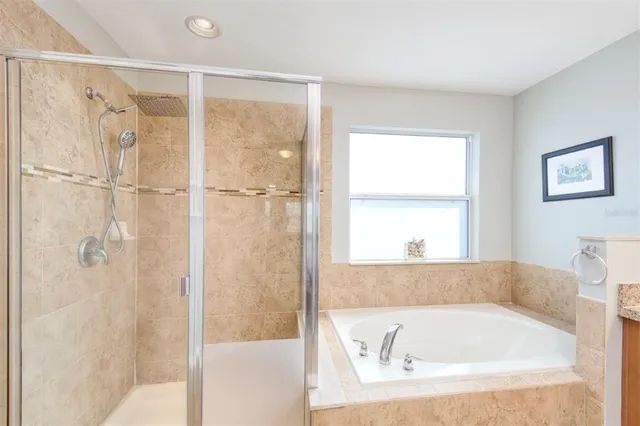 a bathroom with a tub and shower