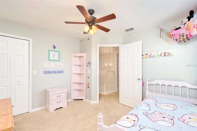 a bedroom with furniture and a chandelier