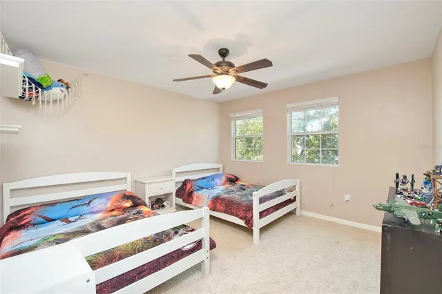 a bedroom with two beds and a chandelier
