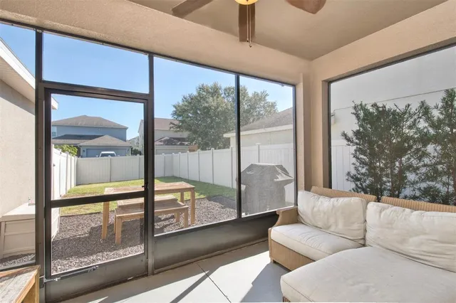 a living room with couch and a floor to ceiling window