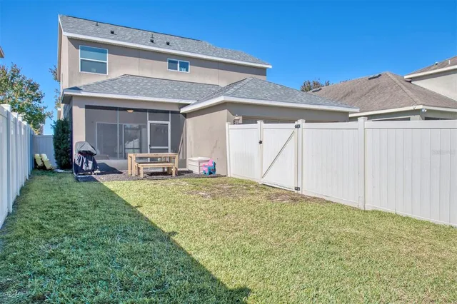a view of a house with backyard and porch