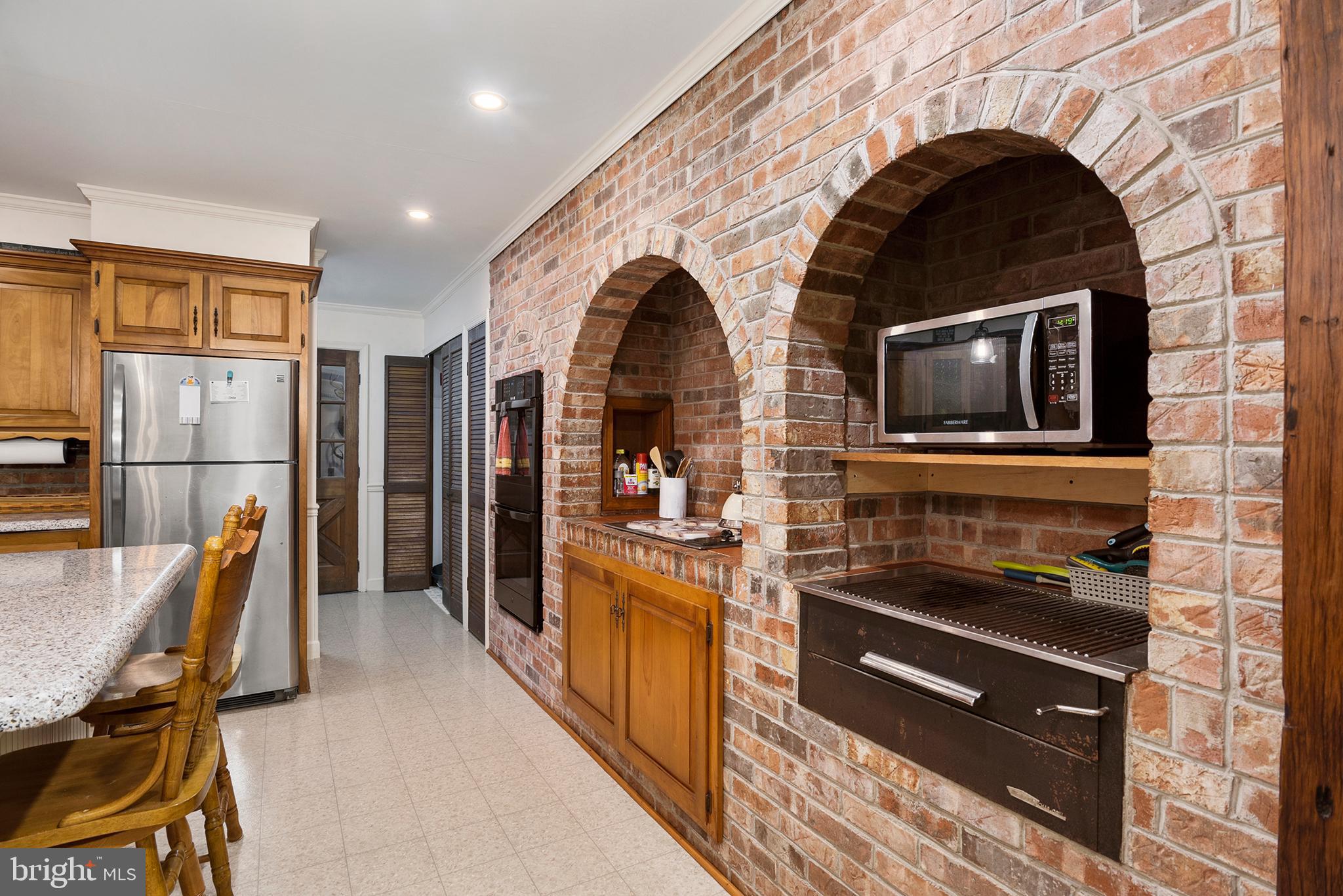 8610 Camp Road Chestertown, MD 21620 - Photo 11 of 38 KITCHEN WITH BRICK WALL ENCASING WALL OVEN/COOKTOP