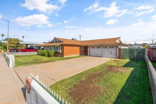 a view of an house with backyard space and balcony