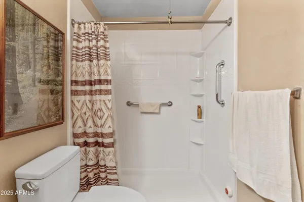 a bathroom with a toilet and shower