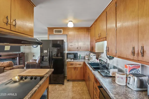 a kitchen with stainless steel appliances granite countertop a sink dishwasher stove and refrigerator