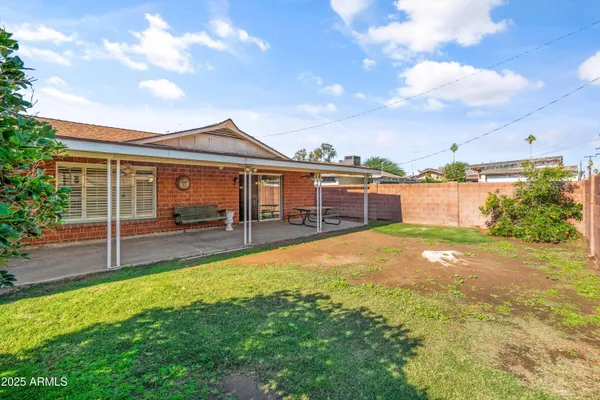 a swimming pool with outdoor seating and yard