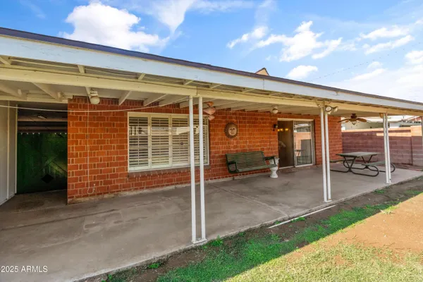 a view of a house with backyard porch and sitting area