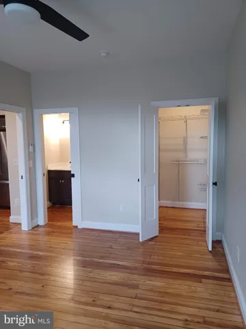 an empty room with wooden floor and closet