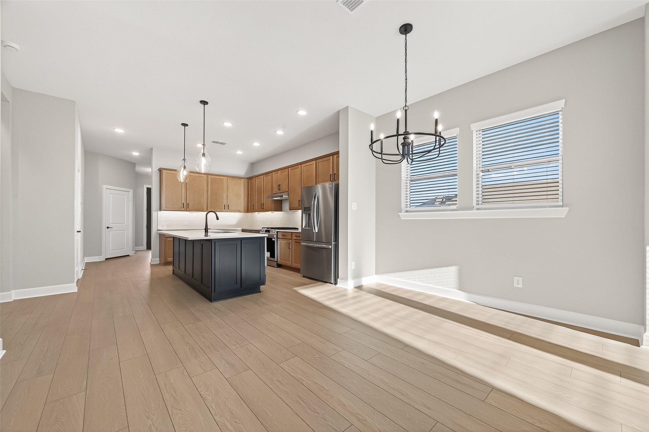 11219 Peacock Flower Street Cypress, TX 77433 - Photo 14 of 50 a large kitchen with a lot of cabinets and stainless steel appliances