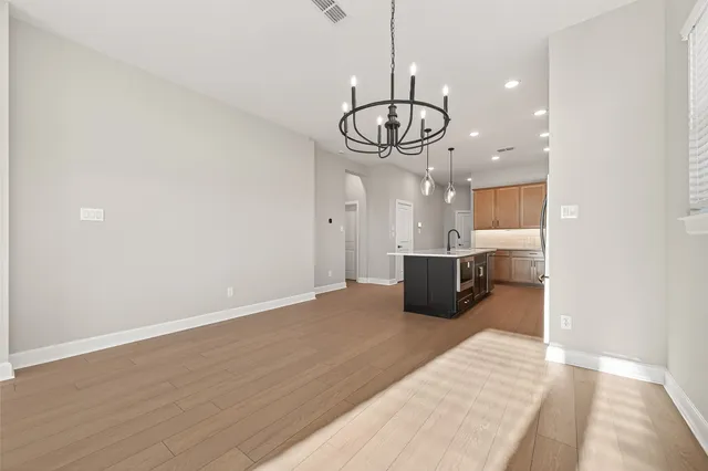 a kitchen with stainless steel appliances granite countertop a refrigerator and microwave