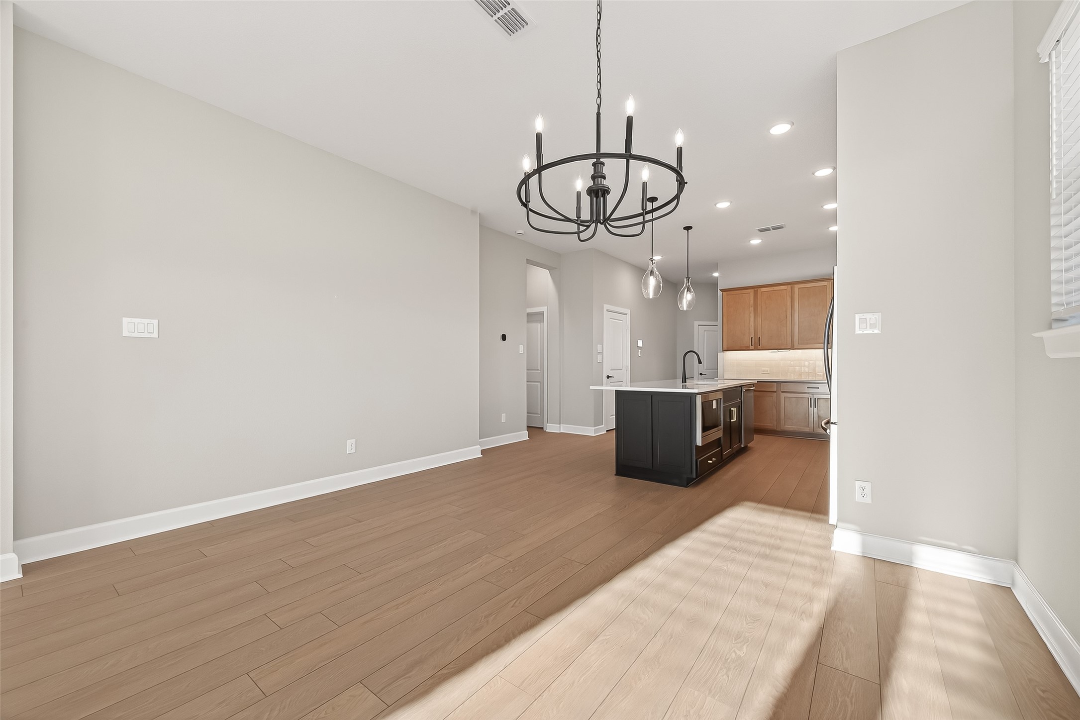 11219 Peacock Flower Street Cypress, TX 77433 - Photo 15 of 50 a view of a room with a chandelier wooden floor and a chandelier