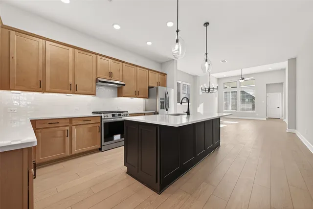 a kitchen with a stove microwave and sink