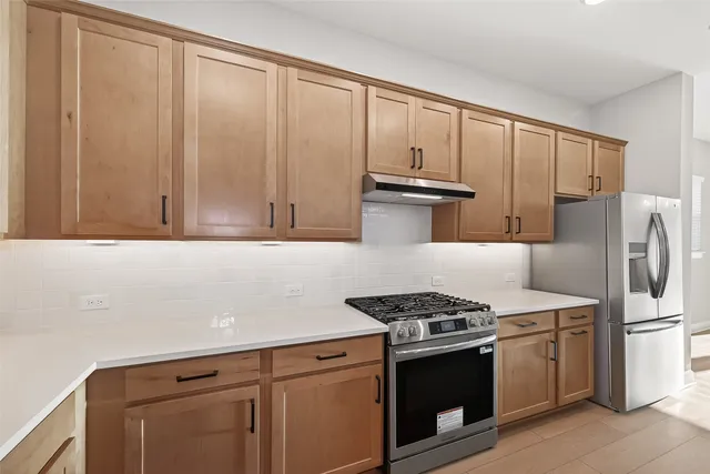 a kitchen with a sink a counter space and wooden floor