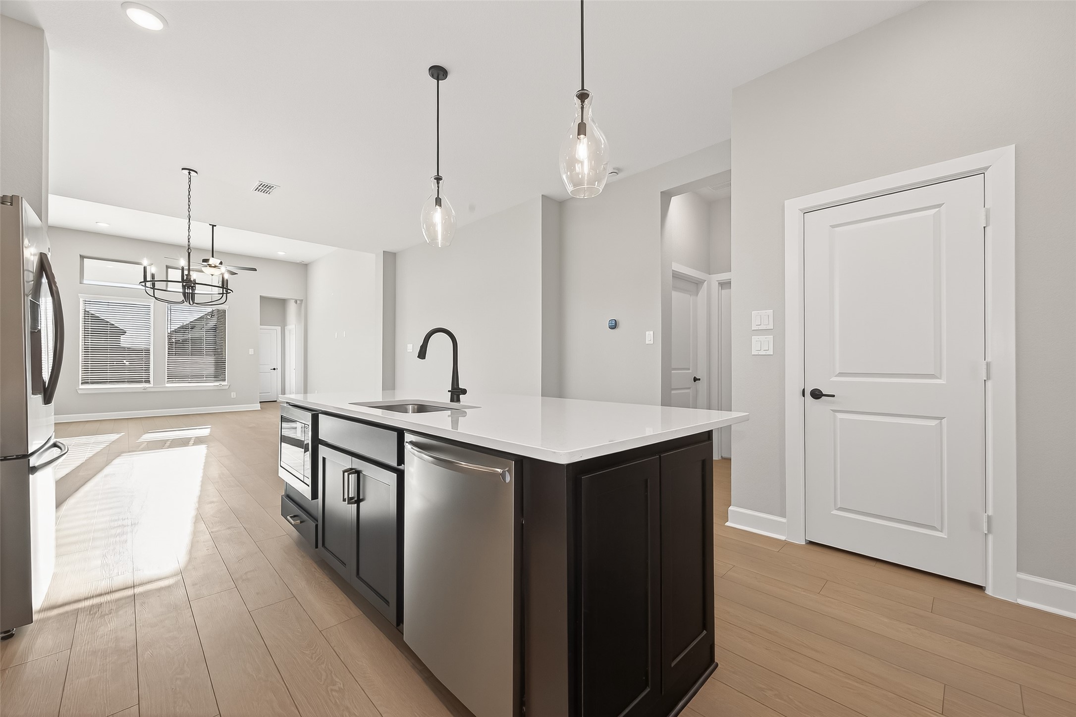 11219 Peacock Flower Street Cypress, TX 77433 - Photo 20 of 50 a kitchen with a sink a counter space and wooden floor