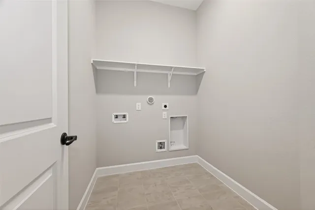 a view of an empty room with closet and a window