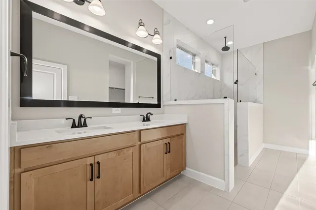 a bathroom with a sink vanity and a mirror