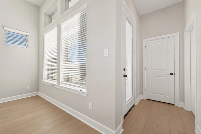 an empty room with fan and entrance