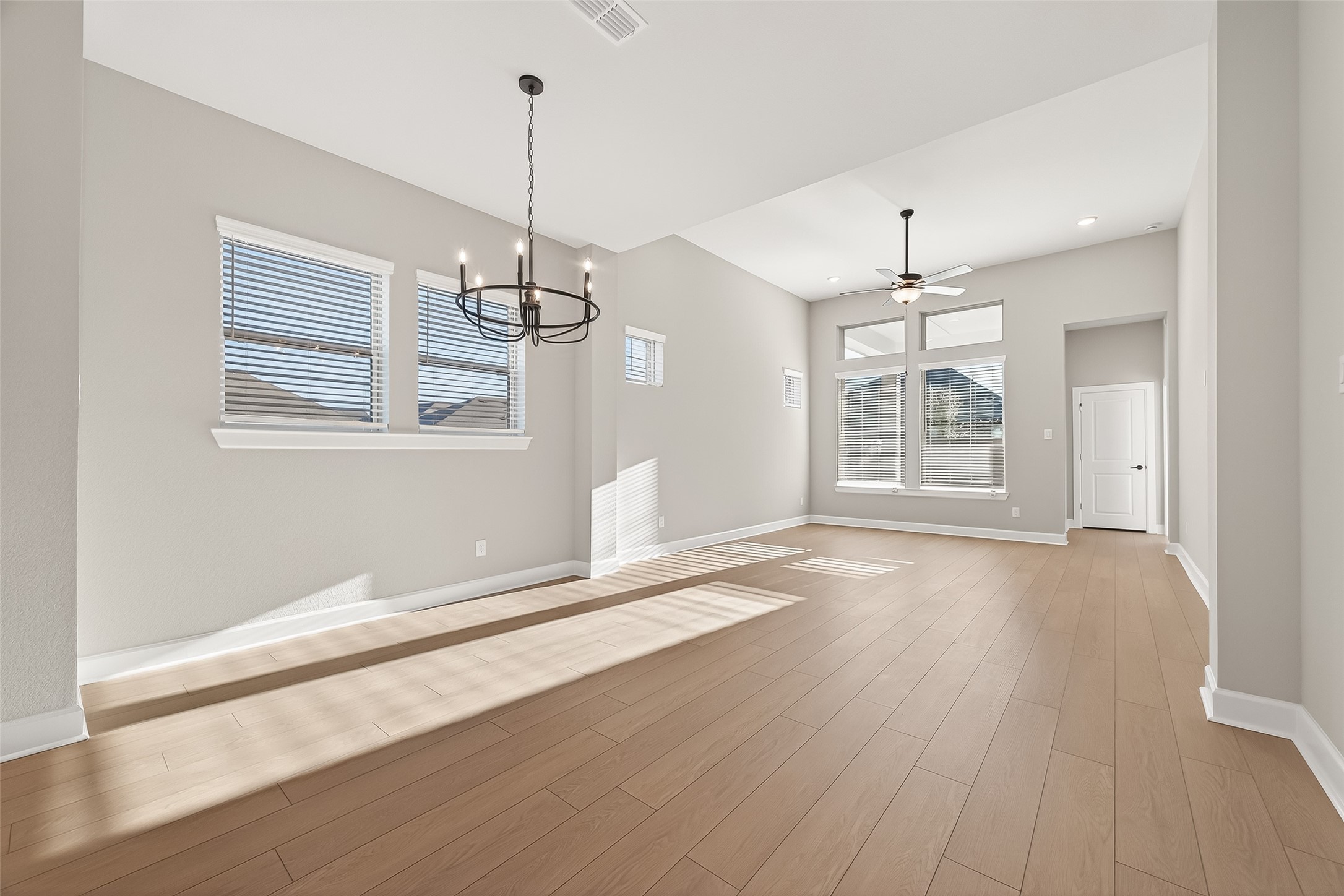 11219 Peacock Flower Street Cypress, TX 77433 - Photo 7 of 50 an empty room with wooden floor and windows